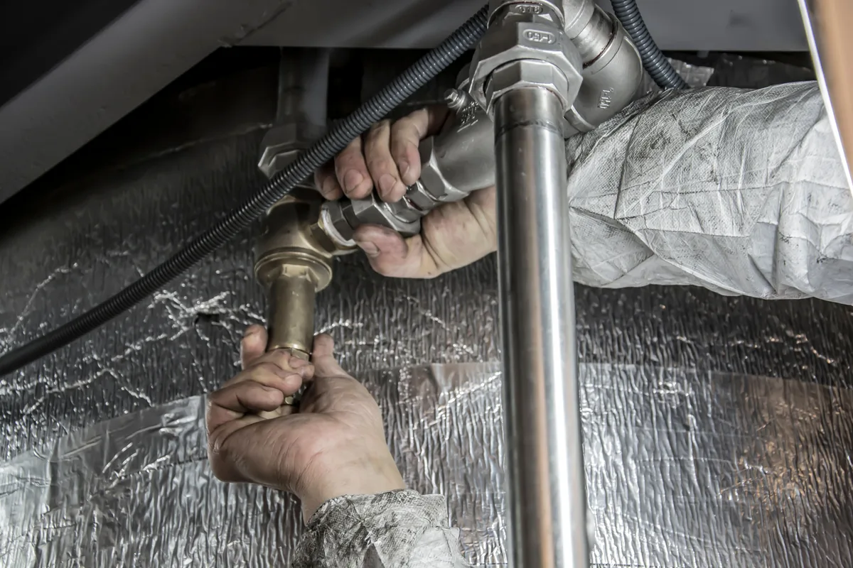 Hands fitting plumbing pipework