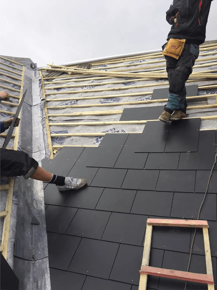 Slate roofing installation in progress